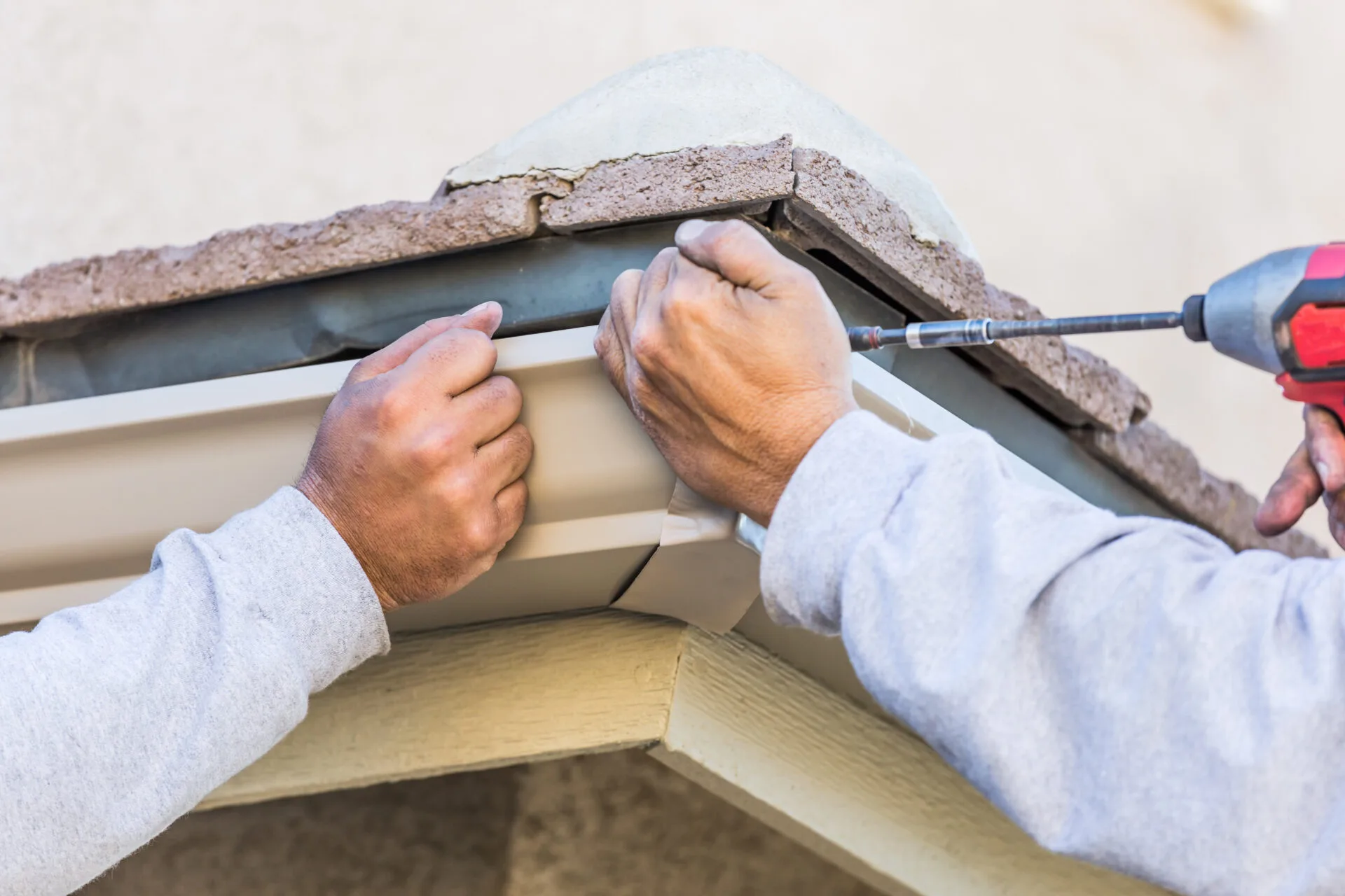 workers attaching aluminum rain gutter to fascia o 2024 09 11 12 54 22 utc